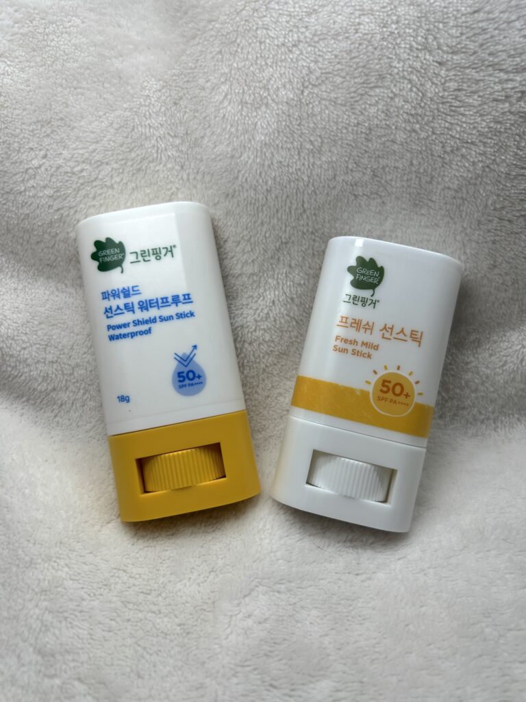 The two Green Finger sun sticks photographed together
