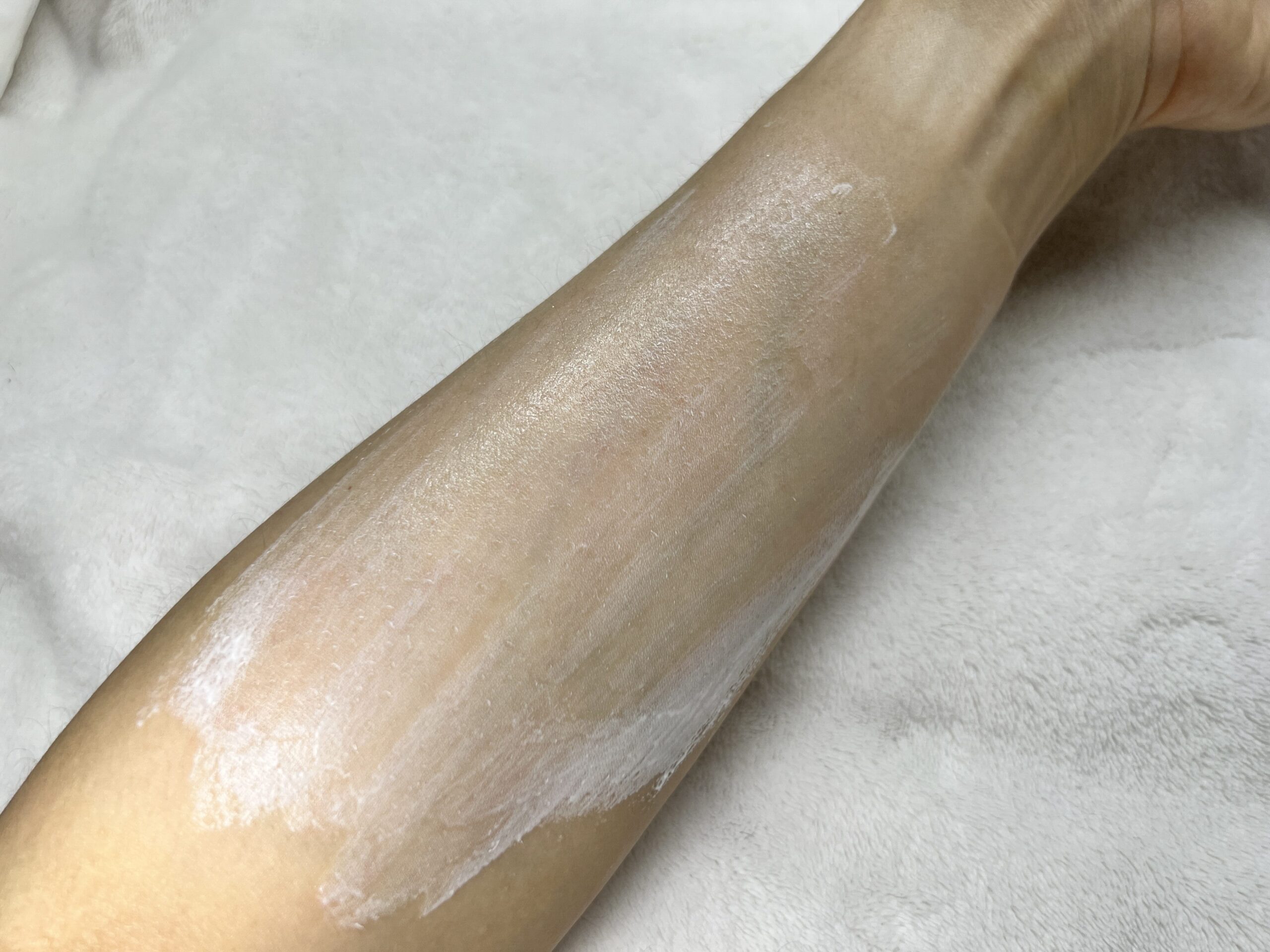 Applying Korean mousse sunscreen on arm