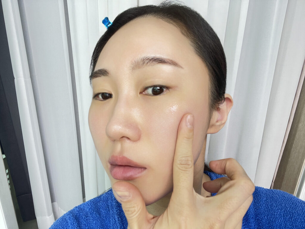 Applying hydrating serum in Korean skin barrier repair routine