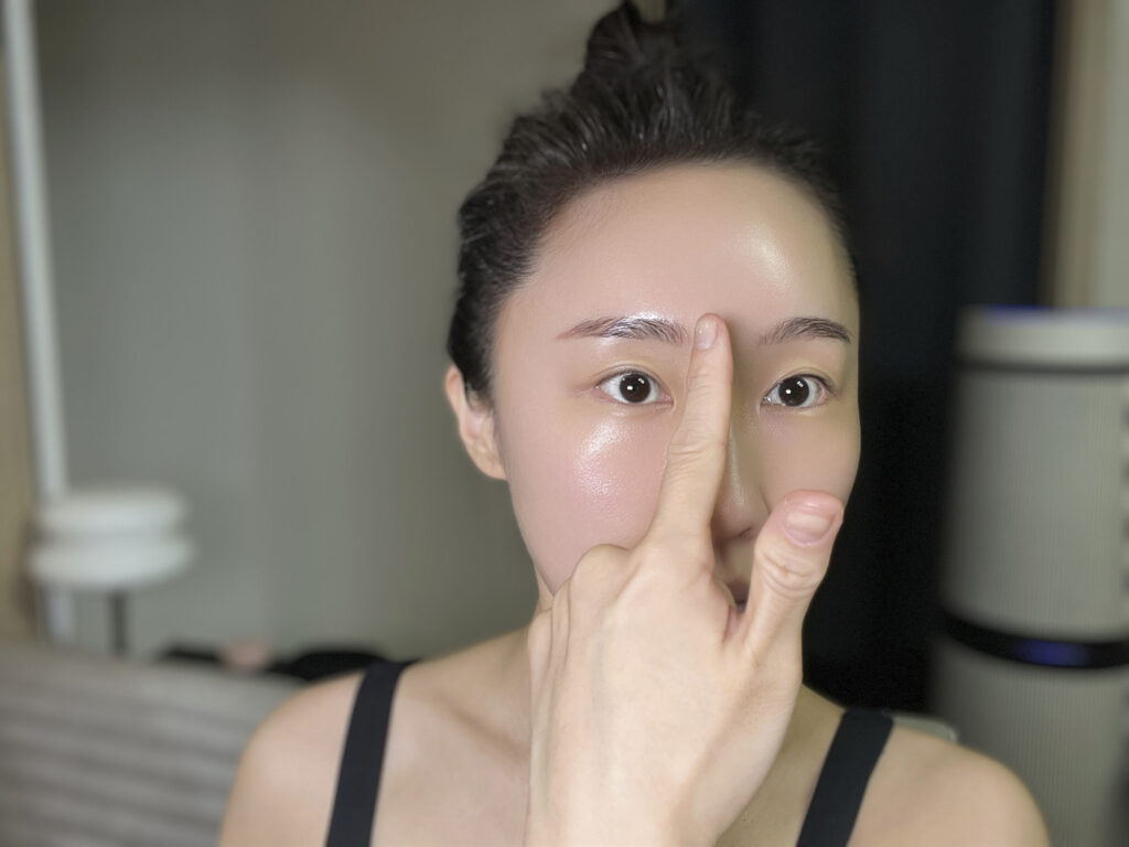 Close-up demonstrating finger placement while applying base prep