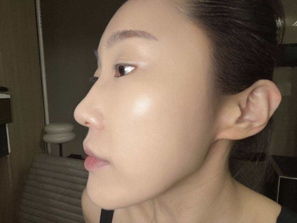 Side profile showing dewy glow on cheek after applying base prep