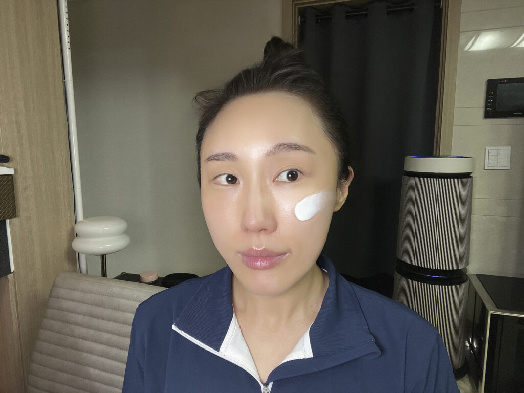 White cream texture of Theraderm Silky Nude SPF 50+ applied to cheek